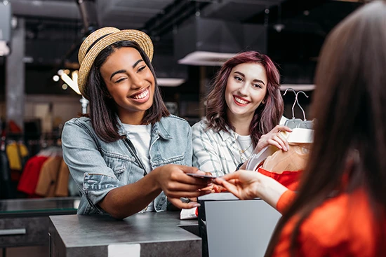 Ladies paying at a boutique